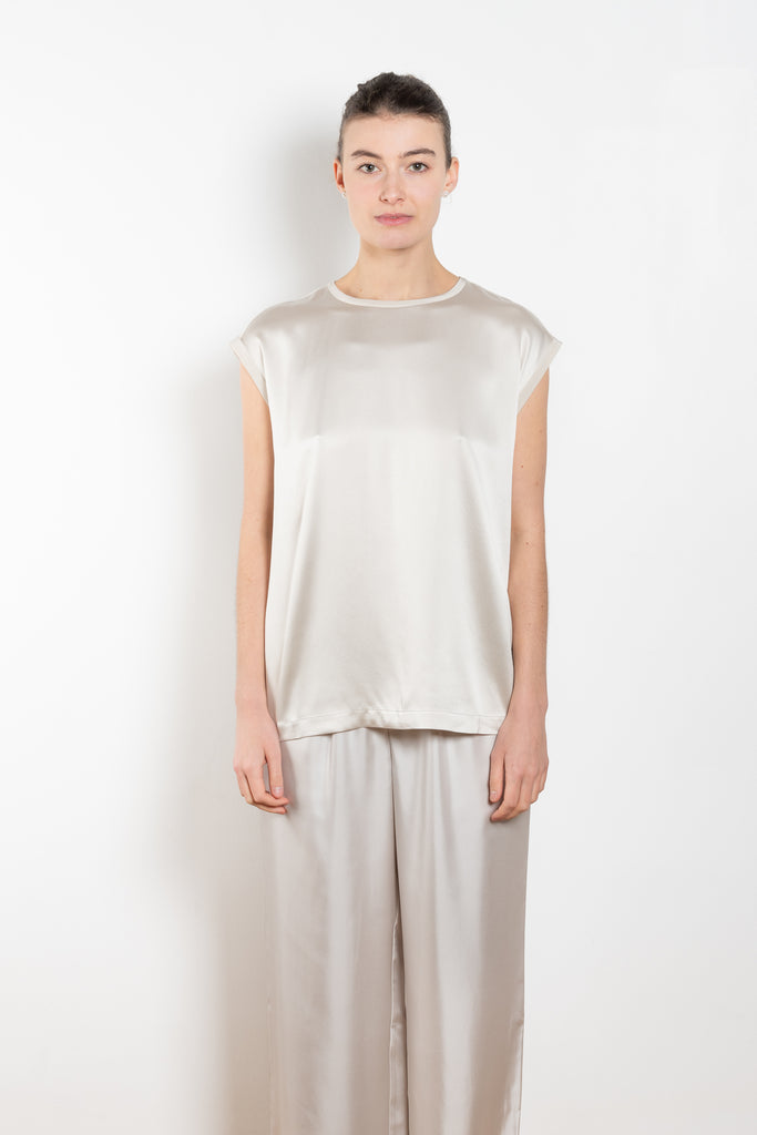 The Round Neck Sleeveless Top by LISA YANG in a woven satin silk, has a neat rounded neckline and relaxed fit silhouette