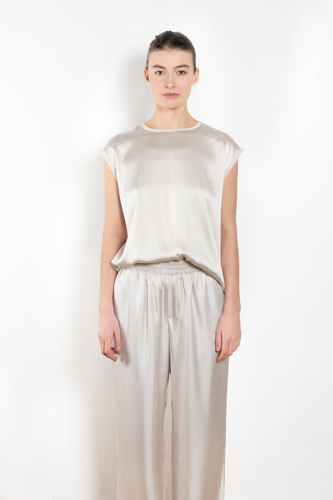 The Round Neck Sleeveless Top by LISA YANG in a woven satin silk, has a neat rounded neckline and relaxed fit silhouette