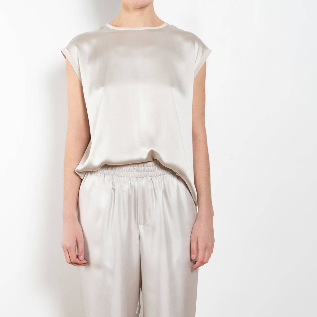 The Round Neck Sleeveless Top by LISA YANG in a woven satin silk, has a neat rounded neckline and relaxed fit silhouette