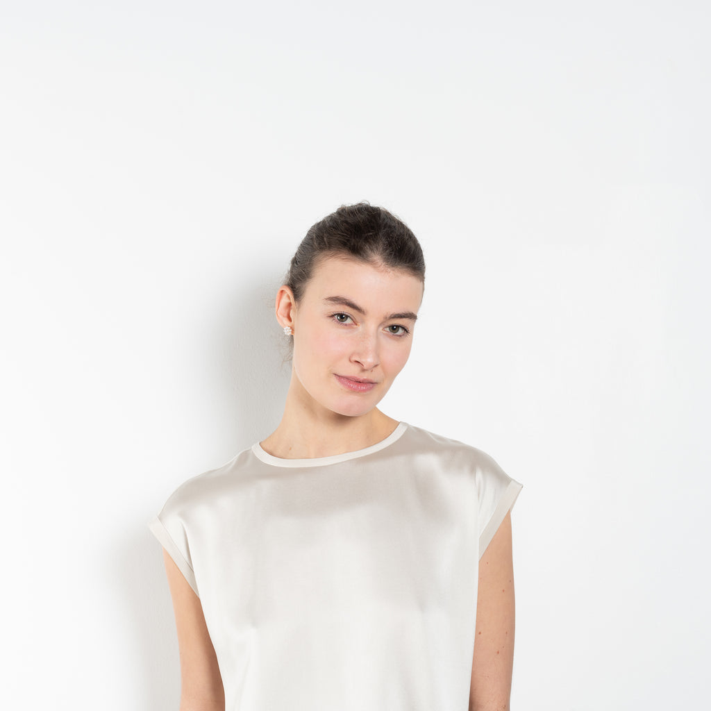 The Round Neck Sleeveless Top by LISA YANG in a woven satin silk, has a neat rounded neckline and relaxed fit silhouette