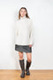 The Therese Sweater by Lisa Yang has a relaxed silhouette with a loose high neck