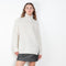 The Therese Sweater by Lisa Yang has a relaxed silhouette with a loose high neck