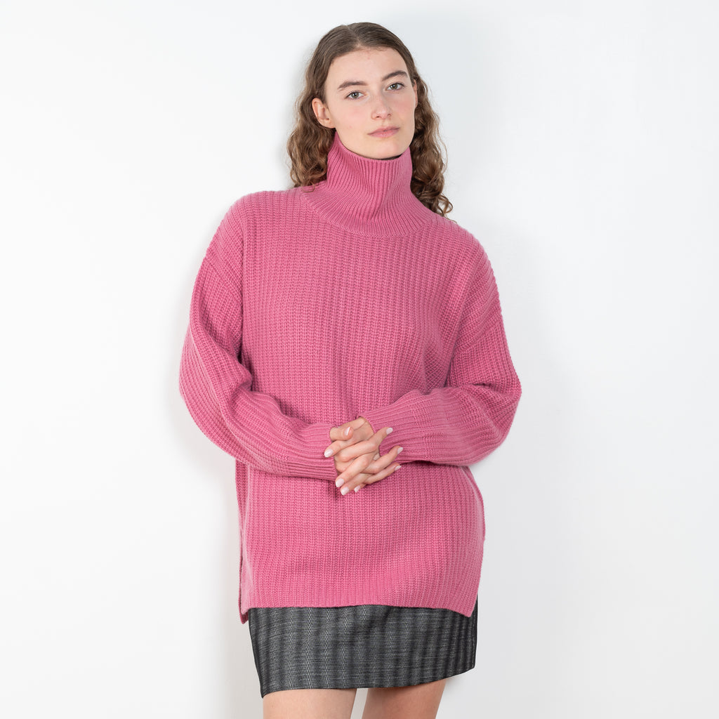 The Therese Sweater by Lisa Yang has a relaxed silhouette with a loose high neck