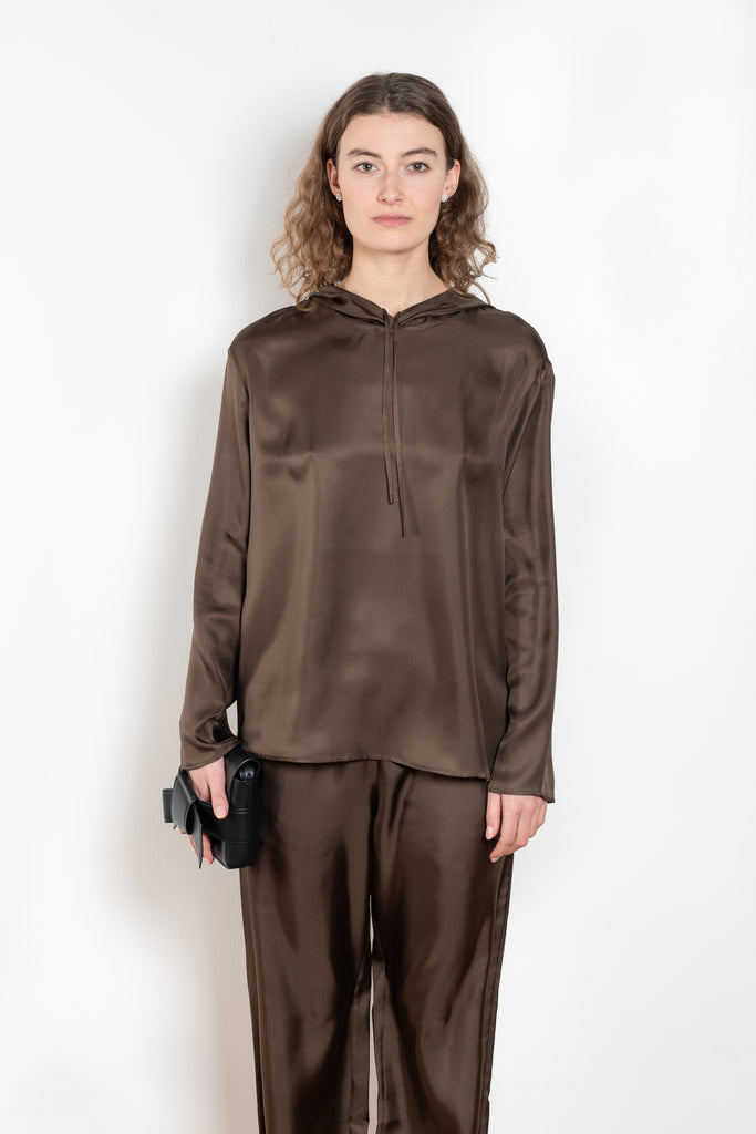 The Nuka Top by Loulou Studio is a hooded top with a relaxed fit in a fluid and lightweight summer silk