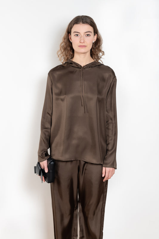 The Nuka Top by Loulou Studio is a hooded top with a relaxed fit in a fluid and lightweight summer silk