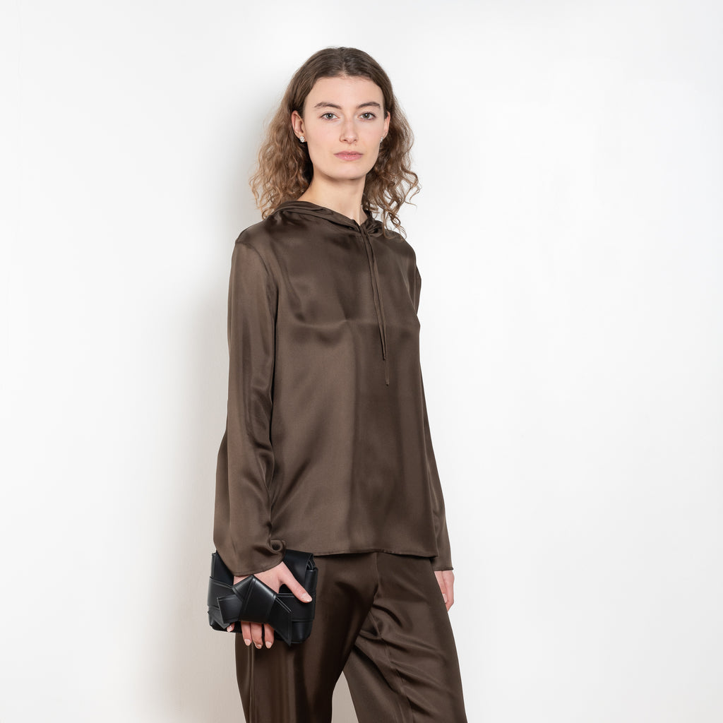 The Nuka Top by Loulou Studio is a hooded top with a relaxed fit in a fluid and lightweight summer silk