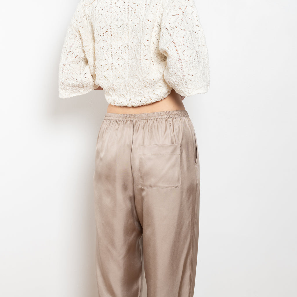 The Alera Trouser by Loulou Studio is a trouser with a relaxed fit in a fluid and lightweight summer silk