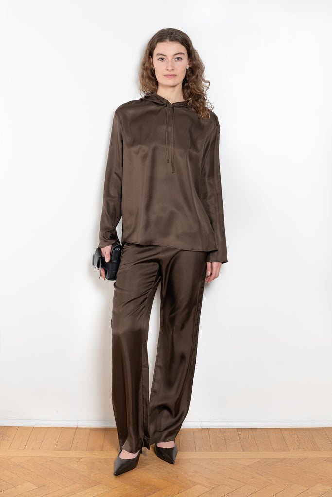 The Alera Trouser by Loulou Studio is a trouser with a relaxed fit in a fluid and lightweight summer silk