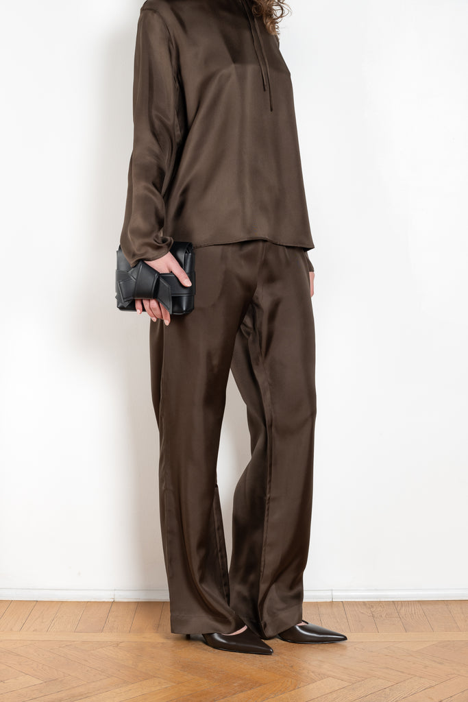 The Alera Trouser by Loulou Studio is a trouser with a relaxed fit in a fluid and lightweight summer silk