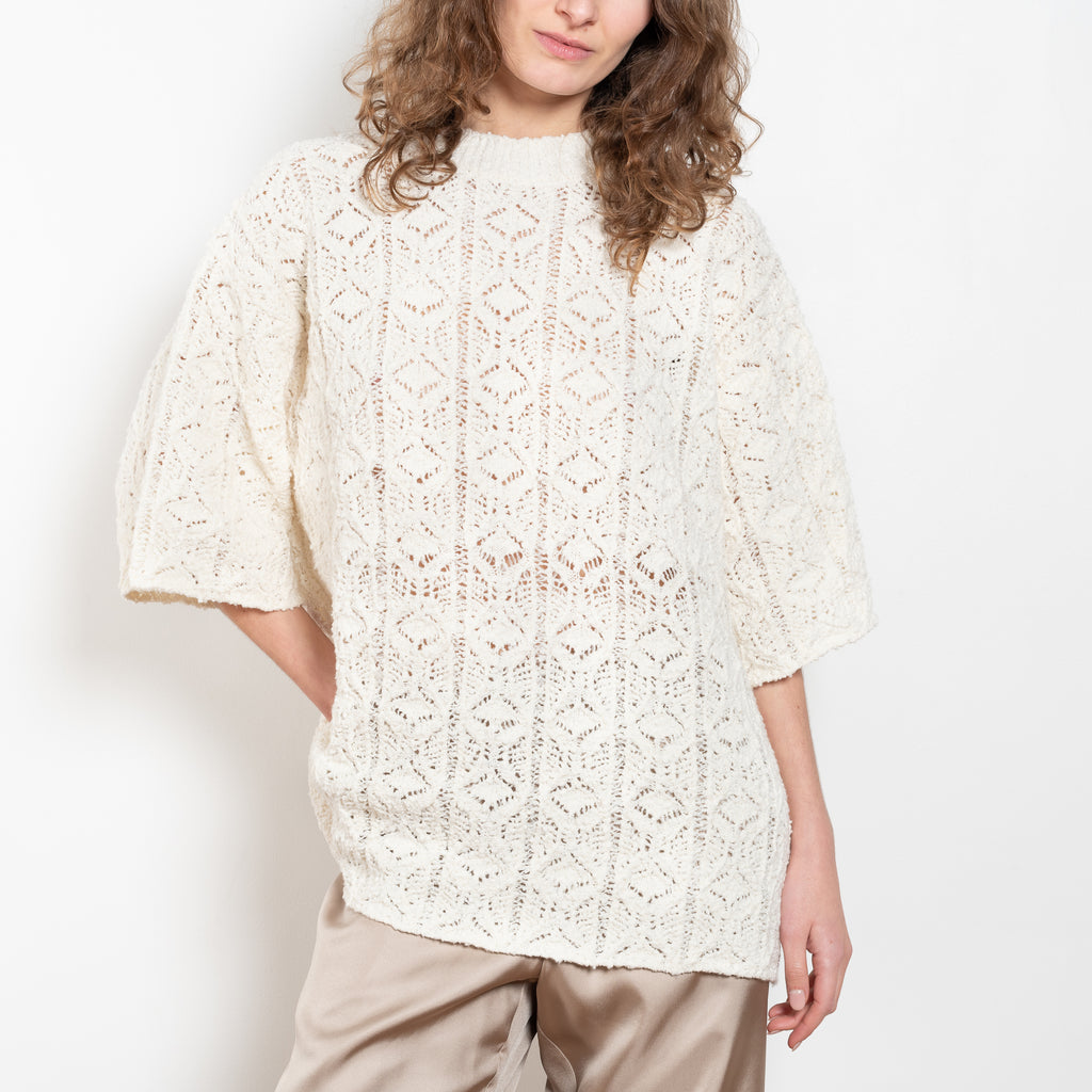 The Antila Top by Loulou Studio is a lace stitch top with a loose fit and wide short sleeves