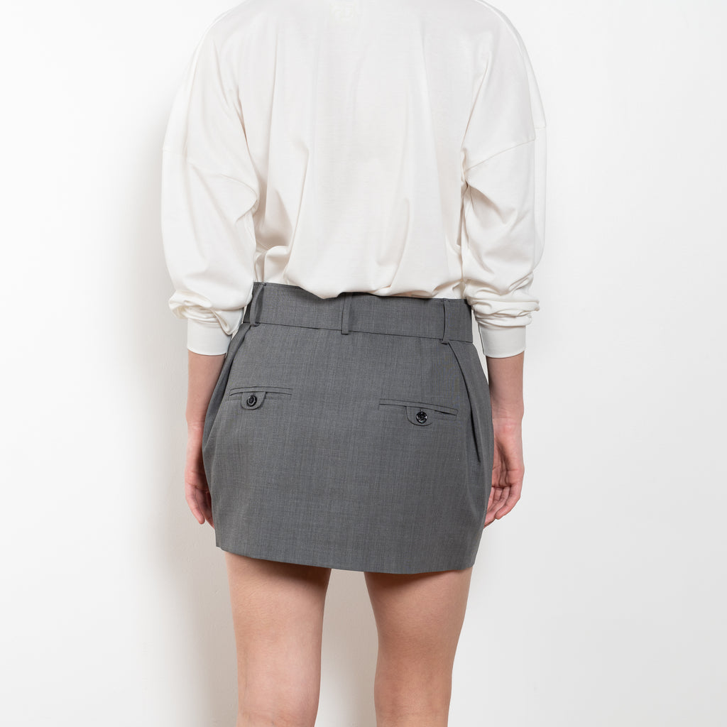 The Belted Mini Skirt by Magda Butrym is an ultra-short, low-waisted mini skirt with a belted waist, perfect for adding a touch of flair to any outfit