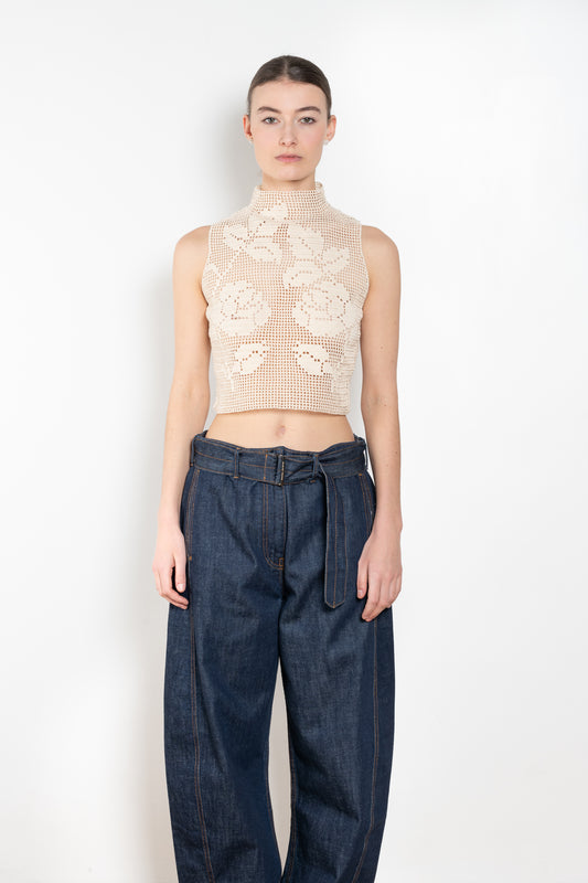 The Crochet Lace Top by Magda Butrym is a cropped top with a high neck and an all-over floral design in traditional Polish crochet technique