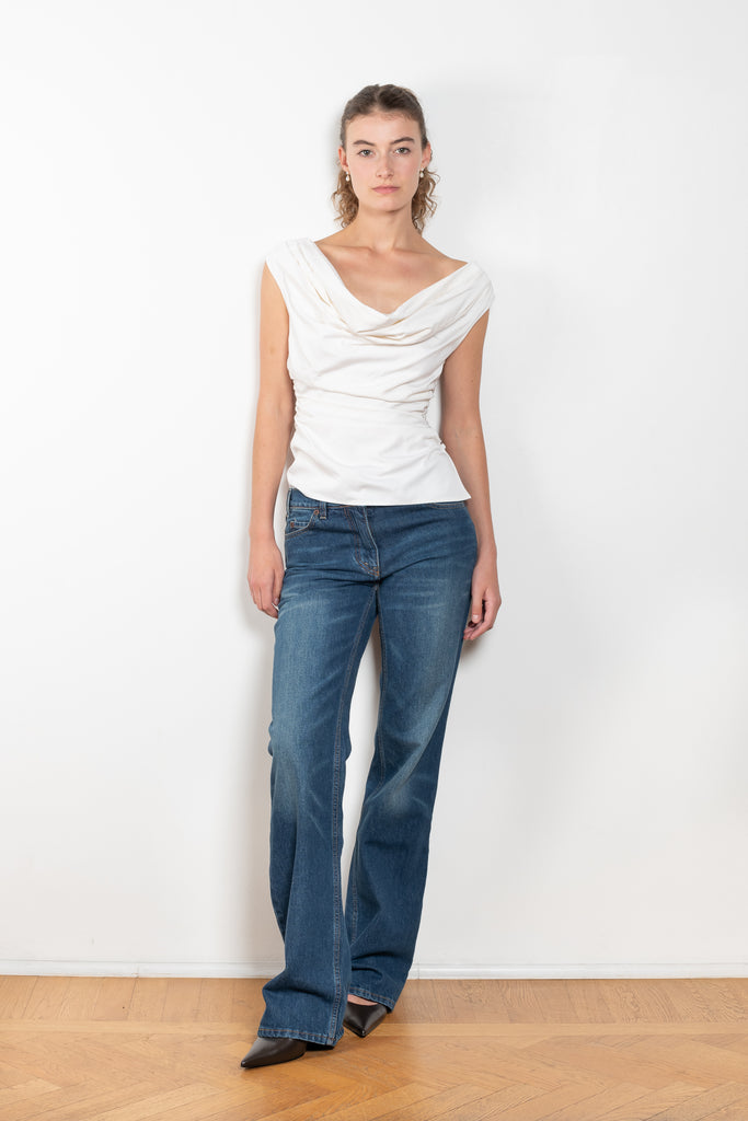 The Flare Denim by Magda Butrym is a low waist, rigid cotton denim with elongated flare legs