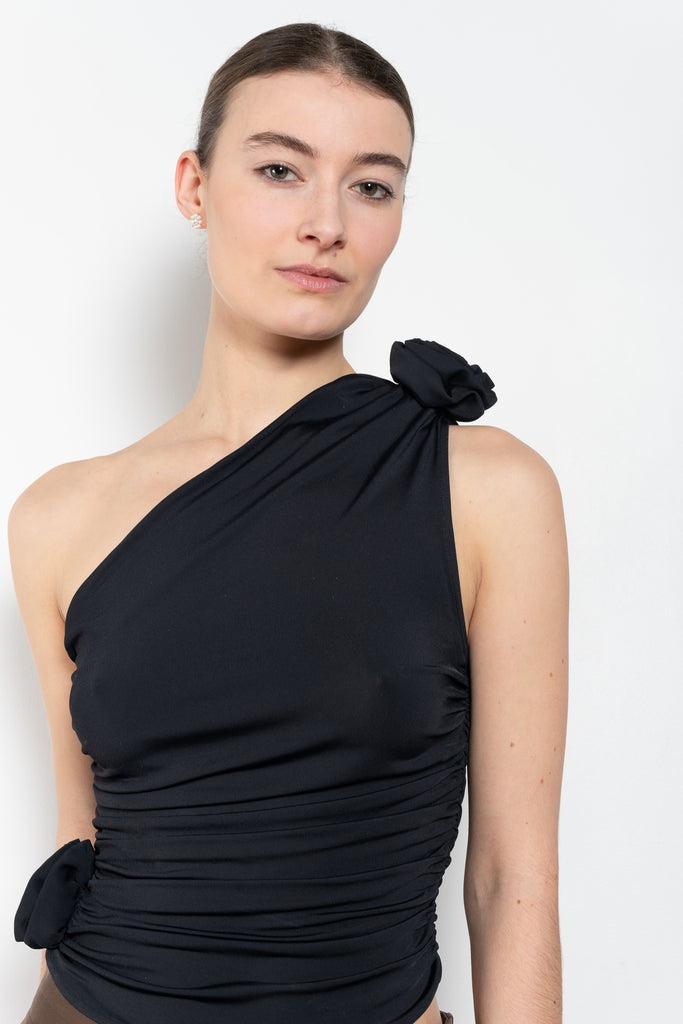 The Off Shoulder Top by Magda Butrym is a lightweight, one-shoulder asymmetrical top with ruched detailing and 3D roses