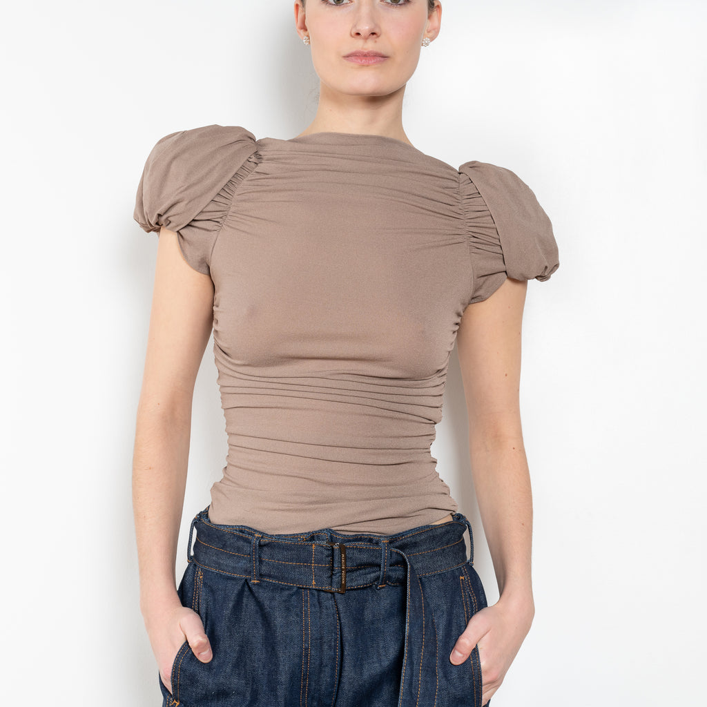 The Puff Sleeve Ruched Blouse by Magda Butrym is a stretch silk top with light ruching down the body and puffed cap sleeves