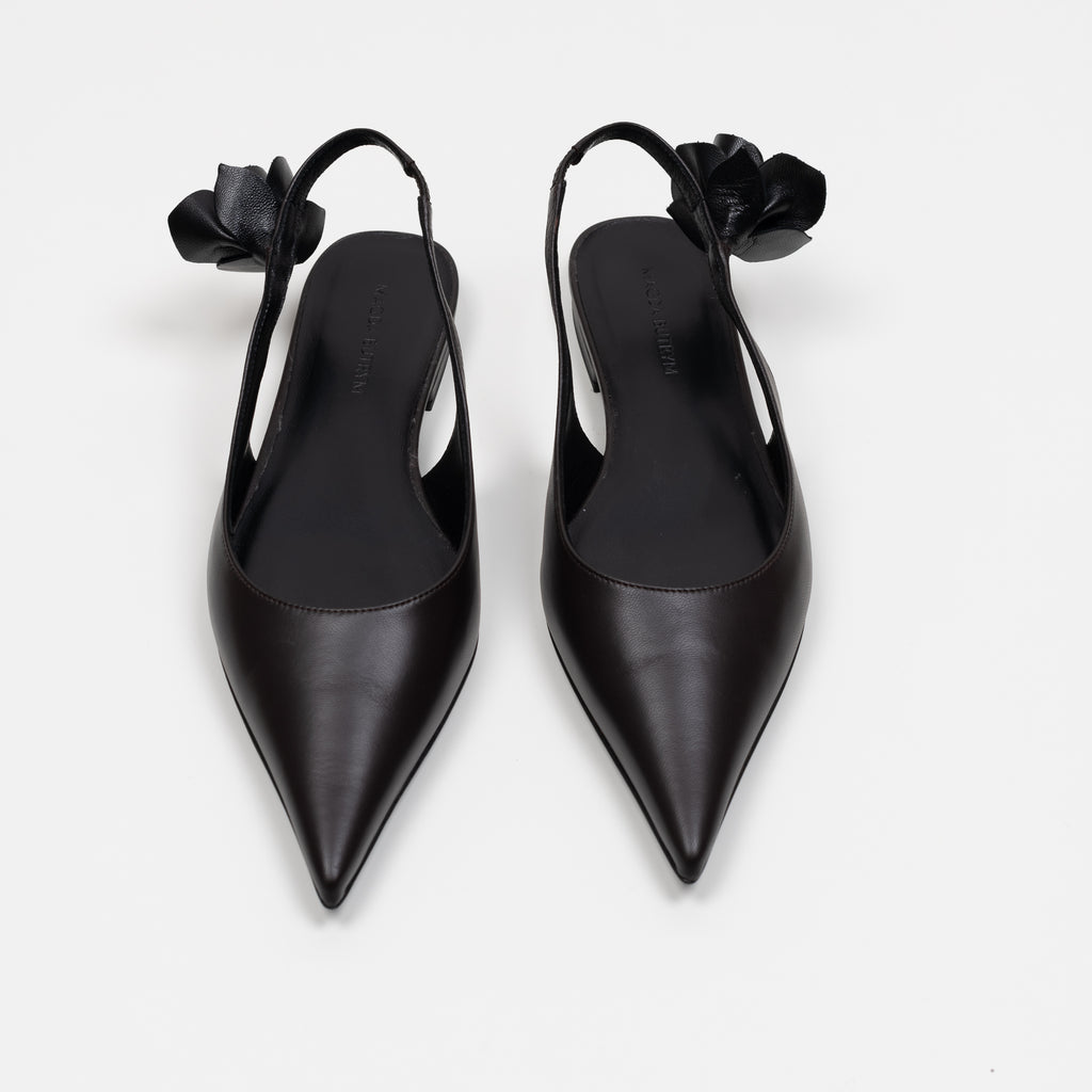 The Slingback Flats by Magda Butrym are classic pointed toe slingback flats with a small rosette embellishment at the heel. Made in Italy