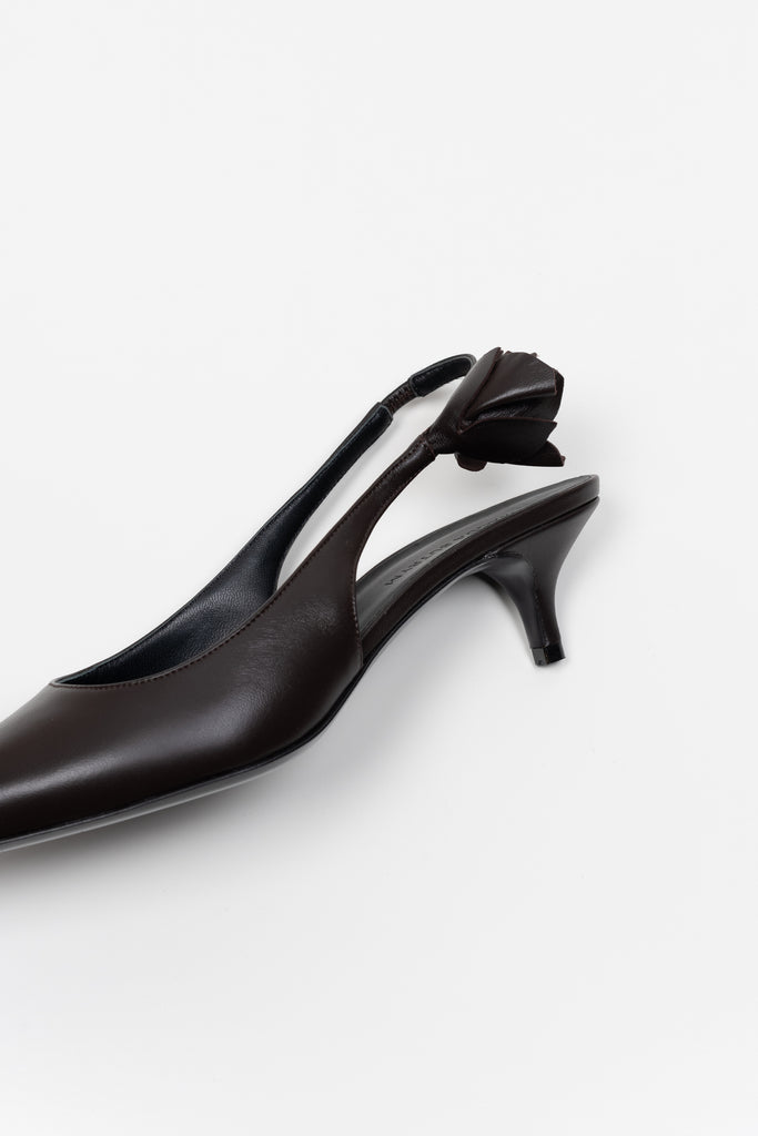 The Slingback Kitten Heels by Magda Butrym are classic pointed toe slingbacks with a small rosette embellishment at the heel. Kitten heels. Made in Italy