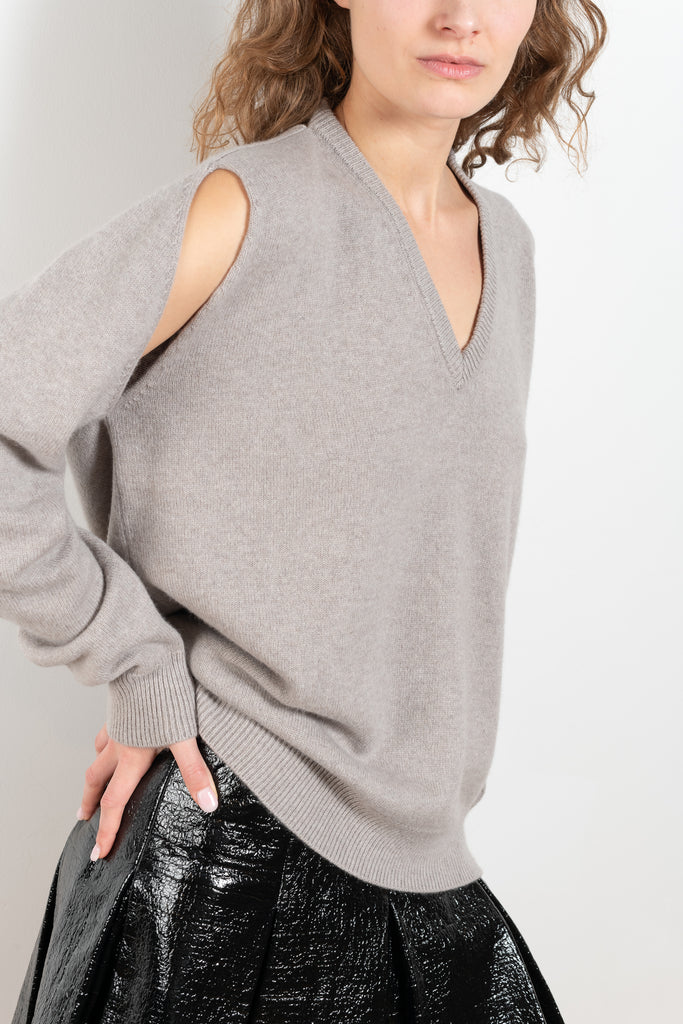 The Cut-out Vneck Sweater by Meryll Rogge is an oversized cashmere sweater with cut-outs at the arms and a deconstructed neckline which can be worn back or front