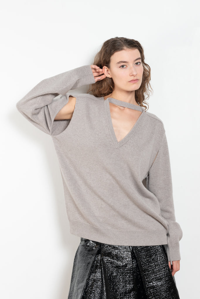 The Cut-out Vneck Sweater by Meryll Rogge is an oversized cashmere sweater with cut-outs at the arms and a deconstructed neckline which can be worn back or front