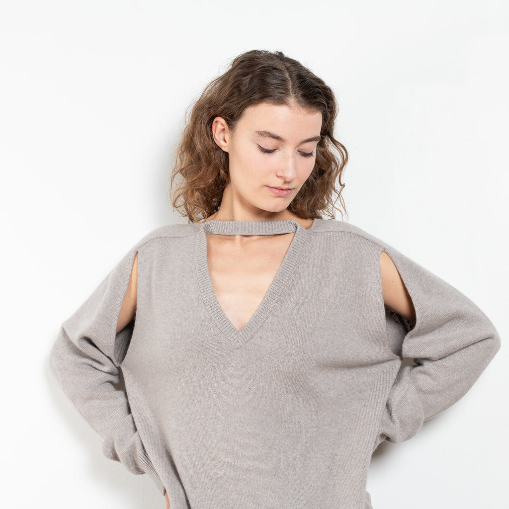 The Cut-out Vneck Sweater by Meryll Rogge is an oversized cashmere sweater with cut-outs at the arms and a deconstructed neckline which can be worn back or front