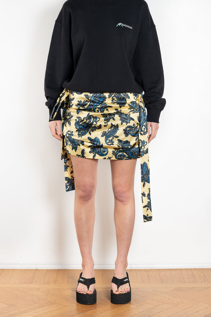 The Drape Skirt with Ties by Meryll Rogge is a mid waist mini skirt with draped details and attached ties and bows on the side