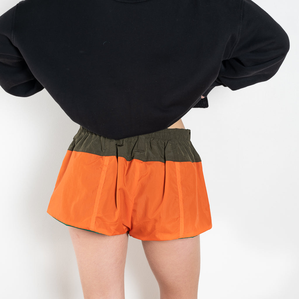 The Track Shorts by Meryll Rogge is a nylon mini short with track and color block detailing