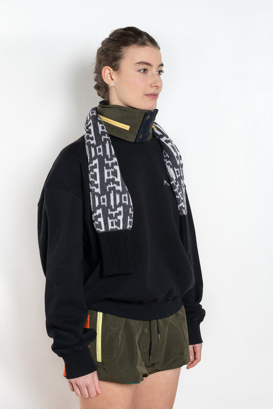 The Hood & Scarf Turtleneck by Meryll Rogge is a signature accessory, a wool scarf with a nylon collar with inserted hood all in one