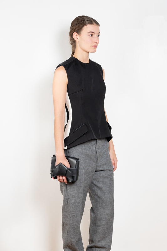 The Tuxedo Top by Meryll Rogge is structured sleeveless top with button detailing on the back and a tuxed band