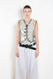 The Plexi Vest with Piping by Meryll Rogge is a ligthweight plexi vest with contrasted black piping and buttons