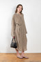 The 10.4 Dress by Monique Van Heist is a loose silk dress that can be tied at the waist