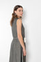 The Cyclamen Dress by Nackiye is an elegant sleeveless dress with a handkerchief detail on the skirt