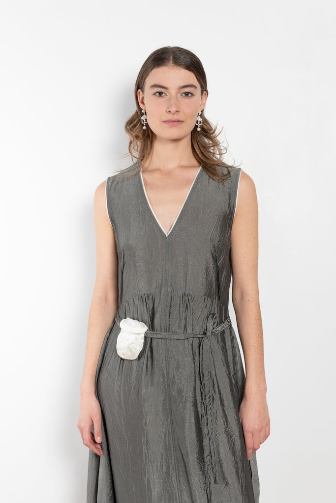 The Cyclamen Dress by Nackiye is an elegant sleeveless dress with a handkerchief detail on the skirt