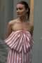 The Dance Floor Gown by Nackiye is a striped bustier dress with a front bow and a back slit