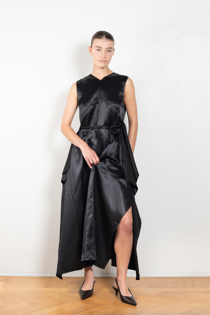 The Into My Arms Dress by Nackiye is an elegant sleeveless dress with a handkerchief detail on the skirt