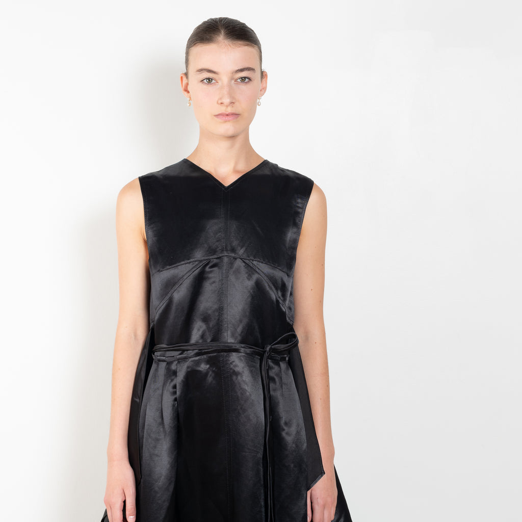 The Into My Arms Dress by Nackiye is an elegant sleeveless dress with a handkerchief detail on the skirt