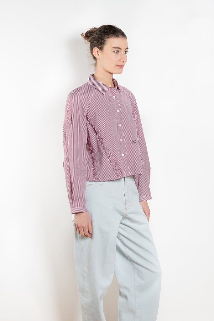 The Moshi Moshi Top by Nackiye is a buttoned up tailored shirt with front and back ruffles running down along the sides