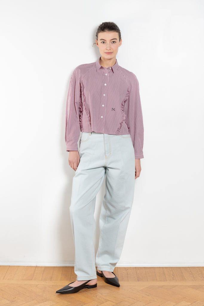 The Moshi Moshi Top by Nackiye is a buttoned up tailored shirt with front and back ruffles running down along the sides