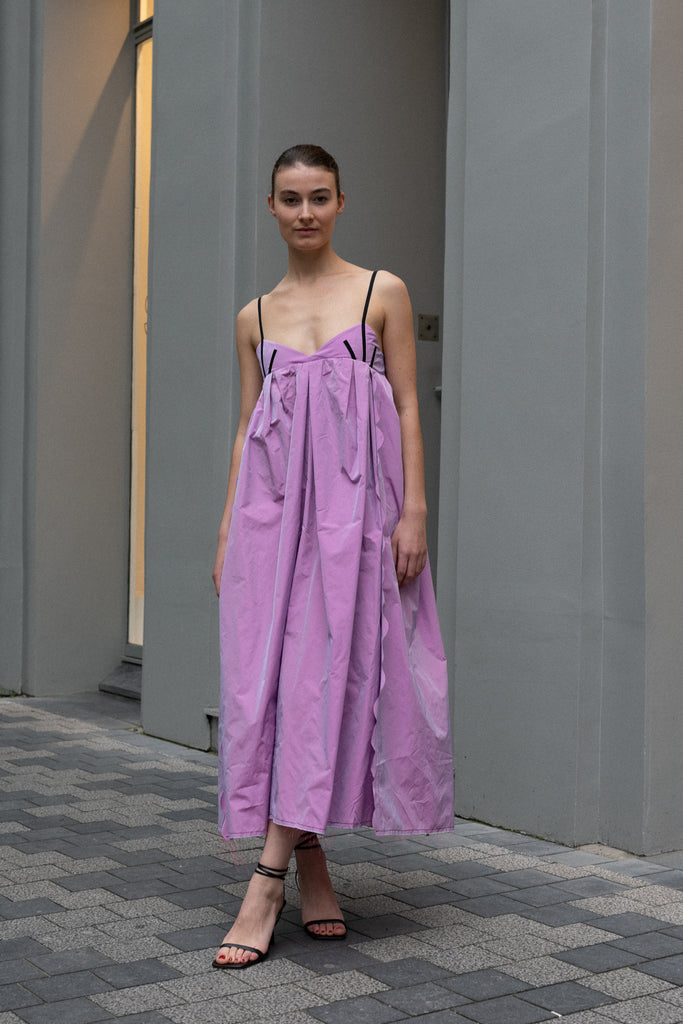 The Octopus Dress by Nackiye is a flowy dress with scalloped edges and a playfull contrasted trim