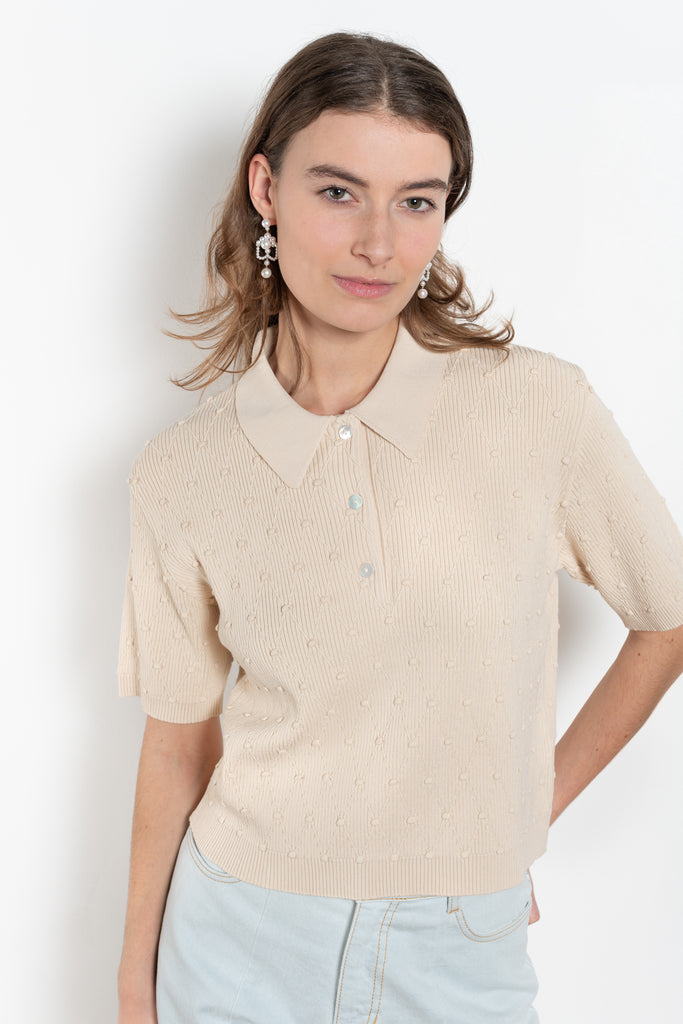 The Polo Swing Top by Nackiye is a structured short sleeved, collared knit with baubles and diamond stitching.