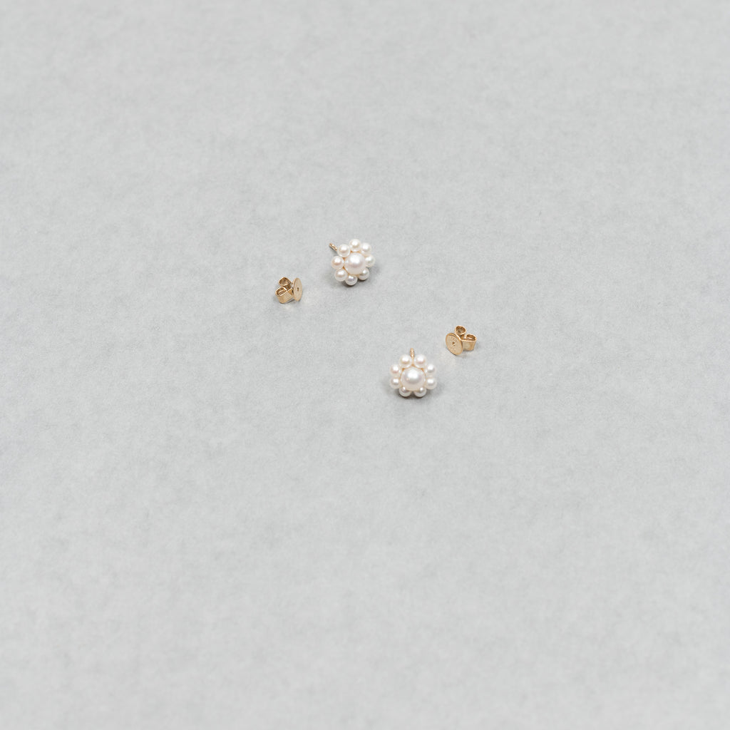 The Margherita Earrings by Sophie Bille Brahe are delicate 14Kt Gold earrings with freshwater pearls arranged to resemble flowers.