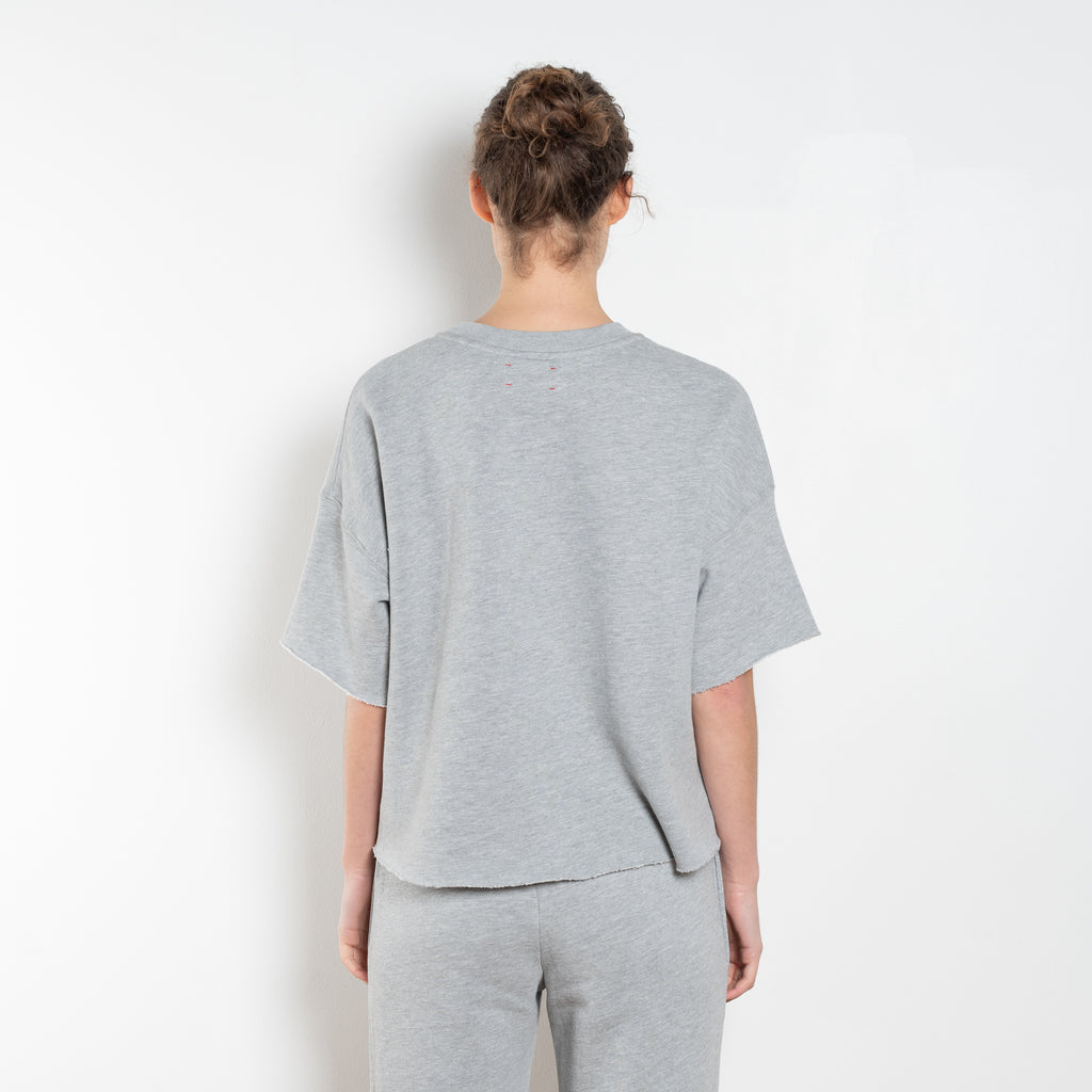 The Romeo Sweatshirt by Xirena is a soft fleece sweater with short sleeves in a slight cropped fit with a raw cut hem