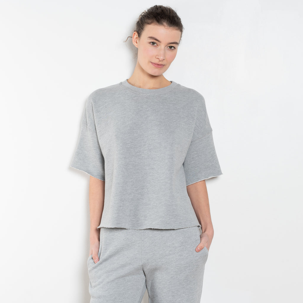 The Romeo Sweatshirt by Xirena is a soft fleece sweater with short sleeves in a slight cropped fit with a raw cut hem