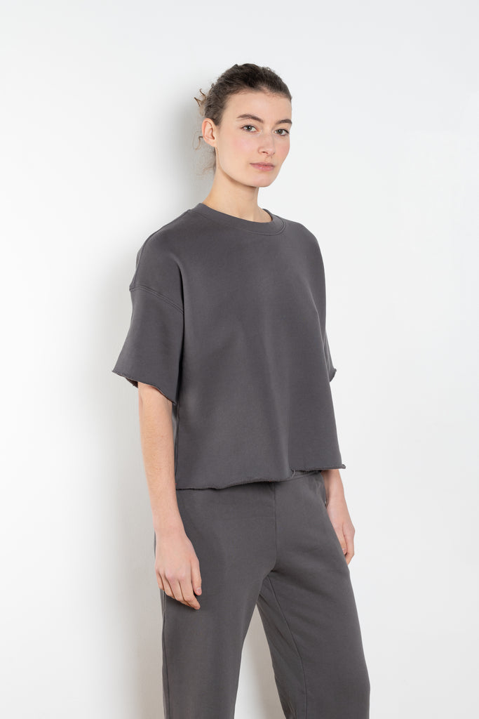 The Romeo Sweatshirt by Xirena is a soft fleece sweater with short sleeves in a slight cropped fit with a raw cut hem