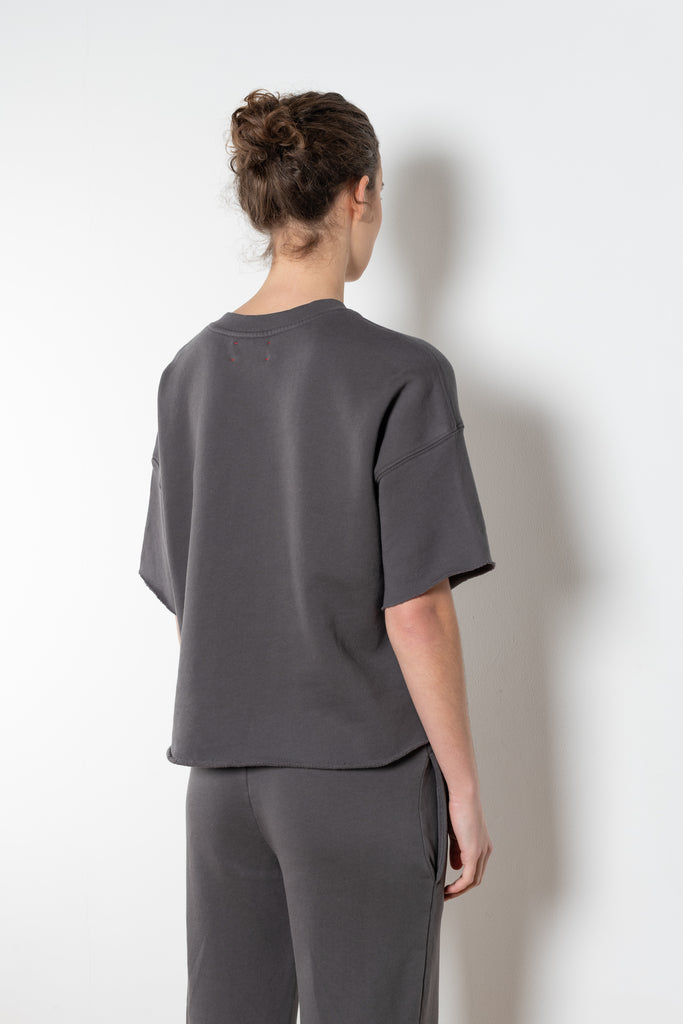 The Romeo Sweatshirt by Xirena is a soft fleece sweater with short sleeves in a slight cropped fit with a raw cut hem